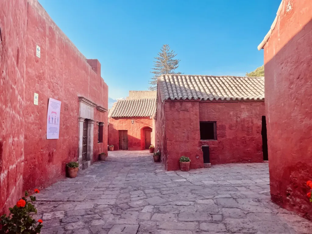 Kamenná ulička mezi červeně omítnutými budovami kláštera Santa Catalina v Arequipě