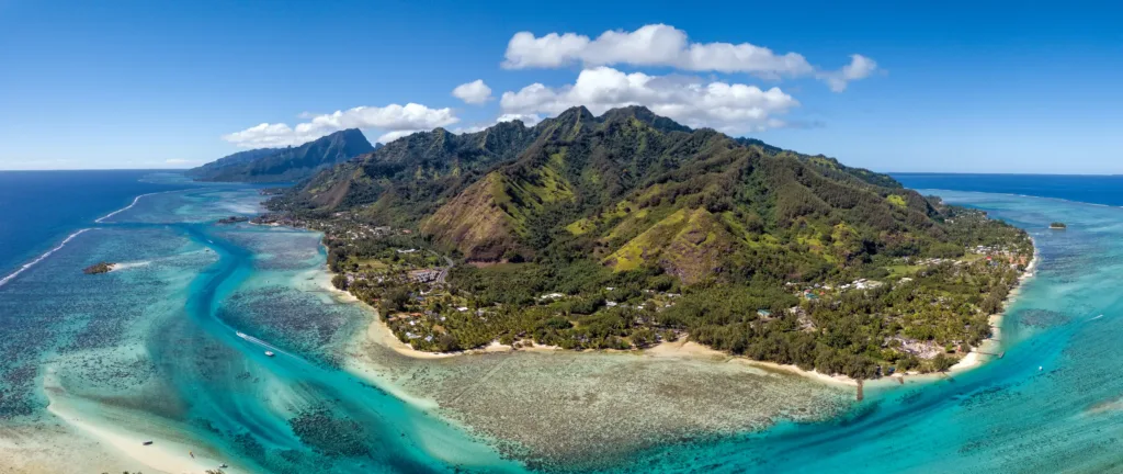 Tyrkysová laguna, korálový útes a zelené hornaté pobřeží ostrova Moorea z výšky.